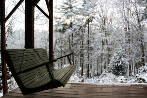 empty porch swing on a snowy day